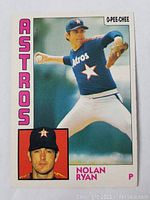 Front side of Nolan Ryan 1984 O-Pee-Chee baseball card showing pitching action photograph and inset portrait.