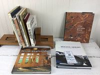 Wooden tabletop book rack holding a collection of architecture and car books, including Arts & Crafts Cabin and Ralph Lauren cars book