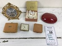 Overall view of clocks, watch and jewelry items on white surface, with seller note showing lot ID and description.