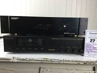 Monster Power HTS2500 Reference Power Conditioner on top of Fosgate Audionics DSL TWO Pro Plus Surround Processor, both black rack-mountable units.