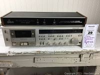 Angled front view of both units stacked, showing overall layout and condition