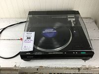 Front view of closed turntable system showing overall condition and dust cover