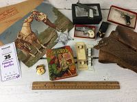 Full lot on white surface showing all items including Roy Rogers poster, Flash Gordon comic, badges, toy guns, leather holster.