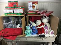 Box with assorted Christmas lights, plates, napkins, and stuffed animals