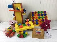 Full view of all toys and items from the lot arranged on table with label