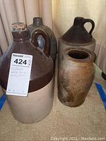 Four crocks arranged on carpet floor, showing the size range and two-tone color crocks.
