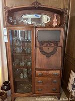 Front view of secretary desk showing glass cabinet and drawers