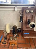 Full view of the lot including wall phone, candlestick phone, ringer box, telegraph key, and slimline phone