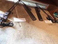 Two fluorescent drafting lamps side by side showing swing arms and bases