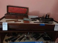 Full display of broach set on table with rulers, tape measure, scale and tools on lower shelf