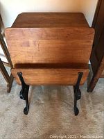 Front view showing the folding seat and wooden desk surface.