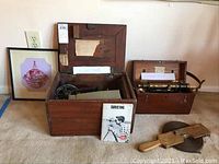 Full lot contents including transits in wooden cases, measuring tape, framed logo, and instruction booklet.