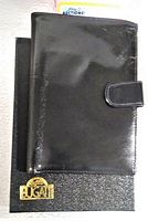 Closed black Bugatti men's billfold wallet on top of the original box showing exterior with snap button flap and Bugatti gold logo on box.