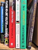Photo showing spines of all six poker strategy books. Titles and authors include Mike Matusow, Phil Hellmuth Jr., Matt Lessinger, Rob Tucker, Tony Guerrera.