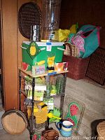 Full view showing kitchen cart stocked with green cooler on top, large plastic beverage dispenser, green and yellow plates, clear plastic cups, and utensils.