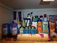 Shelf with deodorants, shampoos, conditioners, sunscreen lotions, sanitary pads, and small personal care items
