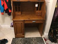 Front view of desk open showing interior cubbies, drawers and left cabinet closed