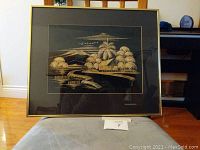 Frontal view of the framed bamboo print showing the detailed artwork and gold trimming on the frame.