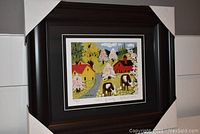 Framed and matted art print in dark wood frame with white matting showing the full artwork and frame.