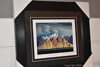 Framed and matted 'Bylot Island' fine art print by Lawren Harris, showing overall front view with protective corner covers on frame.