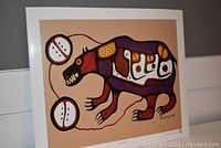 Full view of the unframed art print titled "Sacred Bear" depicting a stylized bear using vivid colors and traditional Indigenous design style.
