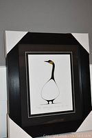 Framed Standing Goose print showing full frame with protective corner coverings.