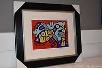 Full view of framed and matted “Thunderbird and Child” print with protective corner guards