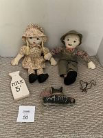 Full view of two vintage farm dolls, wooden milk jug, sweet kitty hanging cat, and wire goose wall hook.