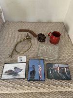 Overall lot showing all items: porcelain shaving mug, bugle, boomerang, insulator, and three pelican photos.