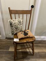 Wooden kitchen chair with two pillows, showing front and detail of items
