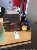 Clear pressed glass fruit compote, two colorful Cuban vases, boxed set of Libbey beer mugs on wooden table