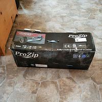 Sealed ProZip branded cardboard box labeled “Fully Loaded Off-Road Scooter.”