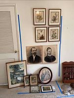 Full overview showing multiple framed art pieces arranged against wall and floor including portraits, bird art, and landscapes