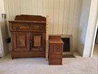 Front view of both cabinets with measuring ruler for scale