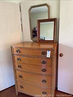 Front view of tallboy dresser with two mirrors on top