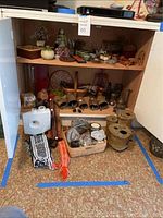 Overall view of two-shelf cabinet with assorted decorative items and floor display