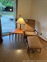 Reclining chair, ottoman, nesting tables and lamp in room view