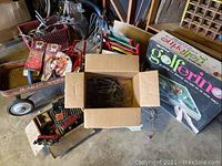 Overview showing wagon loaded with wooden scooter boards, boxed game and train parts