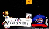 Photo of Blake Griffin bobblehead, Panini trading card inside plastic case, Clippers T-shirt and Clippers cap showing lot contents