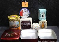 Image showing set of vintage collectible tins on black background