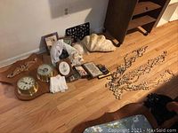 Overall lot view showing barometer plaque, shells, plaques on floor