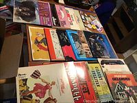 Photo showing various vinyl musical albums including Hair, Godspell, My Fair Lady, Camelot, with visible colorful covers.