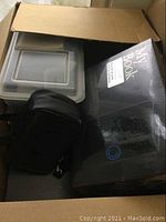 Box showing partially opened Kodak printer, black camera pouch, and Western Digital My Book 400GB hard drive in original box.