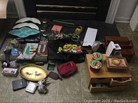 Image showing a wide assortment of the lot including jewelry, bowls, rooster platter, bags, and boxes spread out on tiled floor.