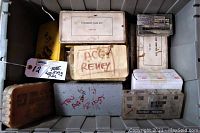 Top view of the tote containing various cam lock pinning kits in labeled boxes and trays.