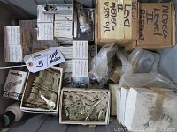 Heavy tote packed with multiple Medeco cylinder boxes, trays of brass keys, and plastic bags of parts