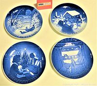 Four B&G porcelain Christmas plates in blue and white showing various winter scenes with dates 1967, 1970, 1971, and 1985 inscribed