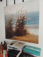 Photo of sea grass print showing natural scene near beach with ocean background, artist signature visible.