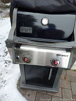 Front view of grill with hood closed