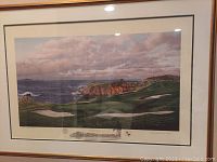 Framed print of The 8th Hole at Pebble Beach Golf Links in gilt frame on wall